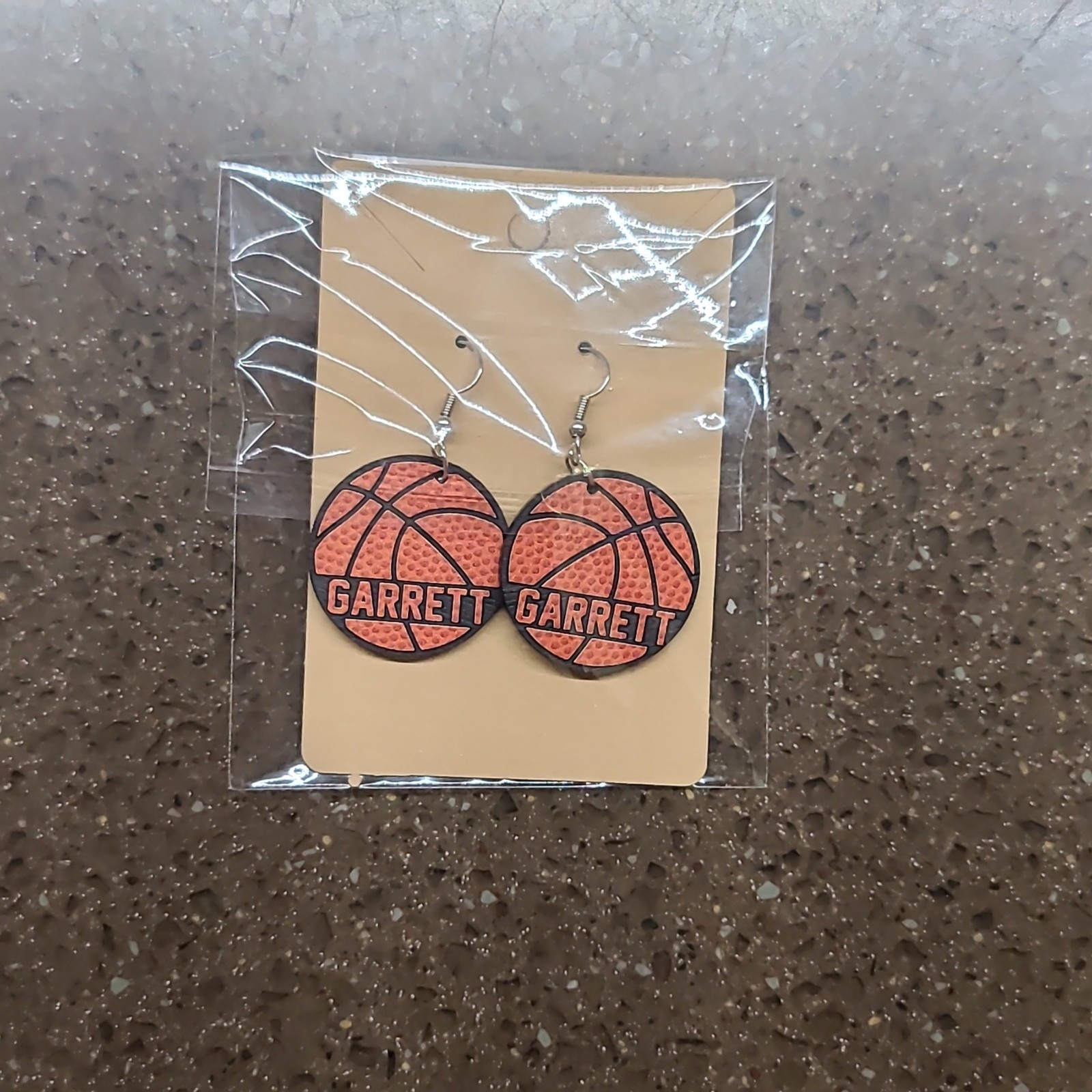 Personalized basketball earrings packaged on a kraft card